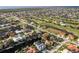 Aerial view showing a large community with golf course, waterways, and numerous houses at 3800 Carupano Ct, Punta Gorda, FL 33950
