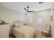 Bright bedroom with a queen bed, ceiling fan, and window shutters at 3800 Carupano Ct, Punta Gorda, FL 33950