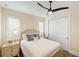 Cozy bedroom with light wood dresser and ceiling fan at 3800 Carupano Ct, Punta Gorda, FL 33950
