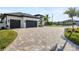 Long paver driveway leading to a two-car garage at 3800 Carupano Ct, Punta Gorda, FL 33950