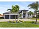 Beautiful two-story home with a modern facade, lush landscaping, and a two-car garage at 3800 Carupano Ct, Punta Gorda, FL 33950