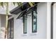 Exterior windows with black accents and shutters at 3800 Carupano Ct, Punta Gorda, FL 33950