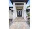 Elegant front entrance with double doors, stone steps, and modern lighting at 3800 Carupano Ct, Punta Gorda, FL 33950