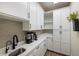White kitchen with coffee bar and ample storage at 3800 Carupano Ct, Punta Gorda, FL 33950