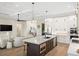 Modern kitchen with white cabinets, large island, and stainless steel appliances at 3800 Carupano Ct, Punta Gorda, FL 33950