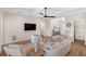 Spacious living room with hardwood floors, comfortable seating, and a large TV at 3800 Carupano Ct, Punta Gorda, FL 33950