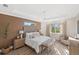 Spacious bedroom with a king-size bed and sitting area at 3800 Carupano Ct, Punta Gorda, FL 33950