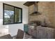 Outdoor kitchen features stainless steel appliances, stone countertops, and built-in sink at 3800 Carupano Ct, Punta Gorda, FL 33950