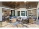 Covered patio with sectional sofa, fireplace, and outdoor kitchen at 3800 Carupano Ct, Punta Gorda, FL 33950