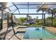 Screened-in pool and spa overlooking a canal with boats at 3800 Carupano Ct, Punta Gorda, FL 33950