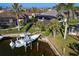 An elevated view of a canal-side home with a private pool and boat lift at 3800 Carupano Ct, Punta Gorda, FL 33950