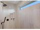 Modern shower with a large window and pebble tile floor at 3800 Carupano Ct, Punta Gorda, FL 33950