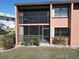 Condo building exterior with lush landscaping and patio at 3919 San Rocco Dr # 31A, Punta Gorda, FL 33950