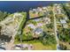 This aerial view showcases the unique neighborhood with waterfront properties, and boat slips on a sunny day at 425 Fireball Ct, Punta Gorda, FL 33950
