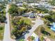 Aerial view of charming single-Gathering home with a well-manicured lawn and mature trees in a desirable neighborhood at 425 Fireball Ct, Punta Gorda, FL 33950