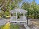 A white, wooden gazebo sits surrounded by lush greenery at 425 Fireball Ct, Punta Gorda, FL 33950