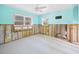 Bedroom featuring a ceiling fan and dual windows in need of renovation at 425 Fireball Ct, Punta Gorda, FL 33950
