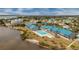 Aerial view of waterfront community with pool and lush landscaping at 4410 Warren Ave # 504, Port Charlotte, FL 33953