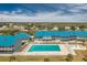Aerial view showing community pool and surrounding buildings at 4410 Warren Ave # 504, Port Charlotte, FL 33953