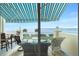 Relaxing waterfront balcony with patio furniture and awning at 4410 Warren Ave # 504, Port Charlotte, FL 33953