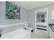 Bathroom with soaking tub and bedroom access at 4410 Warren Ave # 504, Port Charlotte, FL 33953