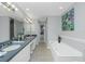 Double vanity bathroom with soaking tub and walk-in shower at 4410 Warren Ave # 504, Port Charlotte, FL 33953