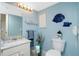 Small bathroom with light blue walls and white vanity at 4410 Warren Ave # 504, Port Charlotte, FL 33953