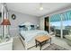 Spacious main bedroom with king bed, water views, and striped awning at 4410 Warren Ave # 504, Port Charlotte, FL 33953