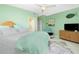 Light green bedroom with double bed and a TV at 4410 Warren Ave # 504, Port Charlotte, FL 33953