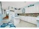 Modern kitchen with white cabinets, granite counters, and a breakfast bar at 4410 Warren Ave # 504, Port Charlotte, FL 33953