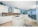 White kitchen with island, granite countertops and water views at 4410 Warren Ave # 504, Port Charlotte, FL 33953