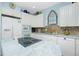 Bright kitchen with island, white cabinets, and stainless steel appliances at 4410 Warren Ave # 504, Port Charlotte, FL 33953