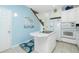 White kitchen with island, stainless steel appliances, and light blue walls at 4410 Warren Ave # 504, Port Charlotte, FL 33953