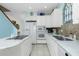 Modern white kitchen with stainless steel appliances and granite countertops at 4410 Warren Ave # 504, Port Charlotte, FL 33953
