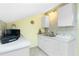 Small galley kitchen with white cabinets and tile countertops at 4410 Warren Ave # 504, Port Charlotte, FL 33953