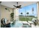 Relaxing lanai with water views, comfortable seating, and ceiling fan at 4410 Warren Ave # 504, Port Charlotte, FL 33953
