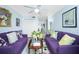 Spacious living room with two purple sofas and a coffee table at 4410 Warren Ave # 504, Port Charlotte, FL 33953