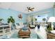 Bright living room with water views, comfortable seating, and ceiling fan at 4410 Warren Ave # 504, Port Charlotte, FL 33953