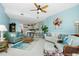 Open living room with kitchen view, comfortable seating, and high ceilings at 4410 Warren Ave # 504, Port Charlotte, FL 33953