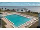 Community pool with ample lounge chairs and waterfront views at 4410 Warren Ave # 504, Port Charlotte, FL 33953