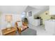 Cozy sitting area with wicker chair and ottoman, near kitchenette at 4410 Warren Ave # 504, Port Charlotte, FL 33953