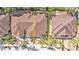 Top-down view of single Gathering home with brown roof and small yard at 4590 Turnberry Cir, North Port, FL 34288