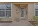 Front entry with decorative wall art and a brick walkway at 4590 Turnberry Cir, North Port, FL 34288