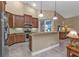 Kitchen features wood cabinets, stainless steel appliances, and an island at 4590 Turnberry Cir, North Port, FL 34288