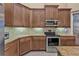 Modern kitchen with granite countertops and stainless steel appliances at 4590 Turnberry Cir, North Port, FL 34288
