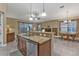 Open kitchen with breakfast bar and views to dining area at 4590 Turnberry Cir, North Port, FL 34288