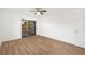 Bedroom with sliding glass doors leading to outdoor area, wood floor, and neutral walls at 5220 Landings Blvd # 104, Sarasota, FL 34231
