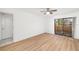 Bedroom featuring wood-look floors and sliding glass door to a balcony at 5220 Landings Blvd # 104, Sarasota, FL 34231