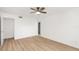 Bright bedroom with wood floors, white walls, ceiling fan, and closet for storage at 5220 Landings Blvd # 104, Sarasota, FL 34231
