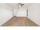 Spacious bedroom featuring wood-look floors, white walls, ceiling fan, and ample natural light at 5220 Landings Blvd # 104, Sarasota, FL 34231